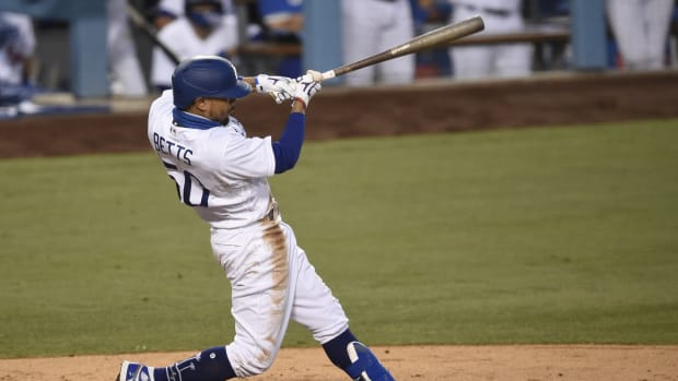 Aug 13, 2020; Los Angeles, California, USA; Los Angeles Dodgers right fielder Mookie Betts (50) hits a solo home run during the fourth inning against the San Diego Padres at Dodger Stadium. Mandatory Credit: Kelvin Kuo-USA TODAY Sports